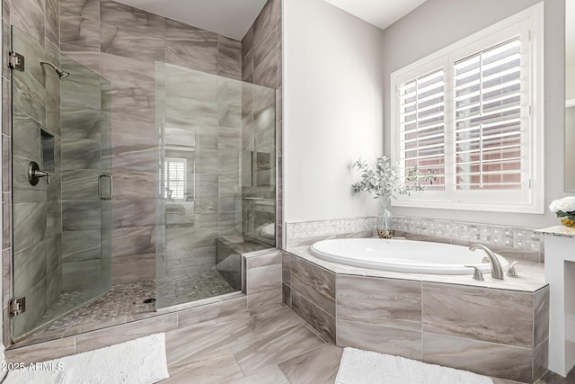 bathroom with a shower stall and a garden tub