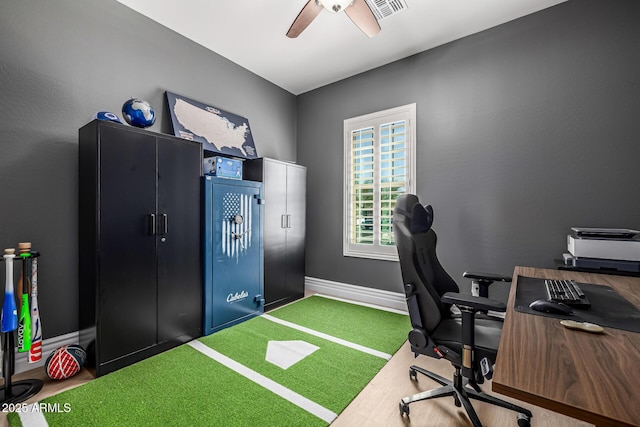 home office featuring visible vents, baseboards, golf simulator, and a ceiling fan