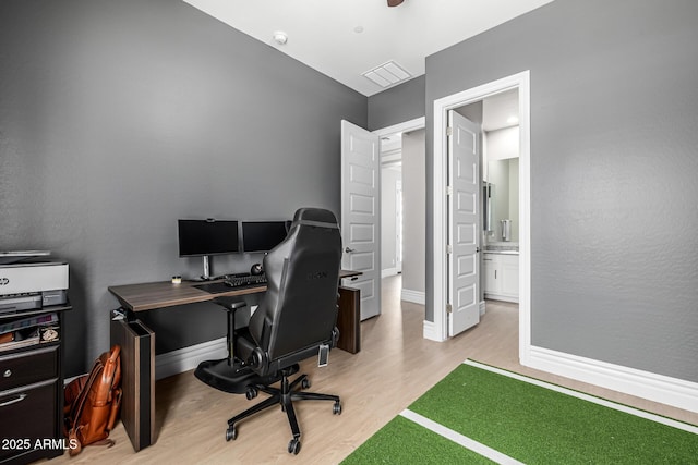 office area with baseboards and wood finished floors
