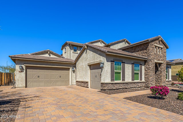 view of front of property featuring stone siding, stucco siding, driveway, and a garage