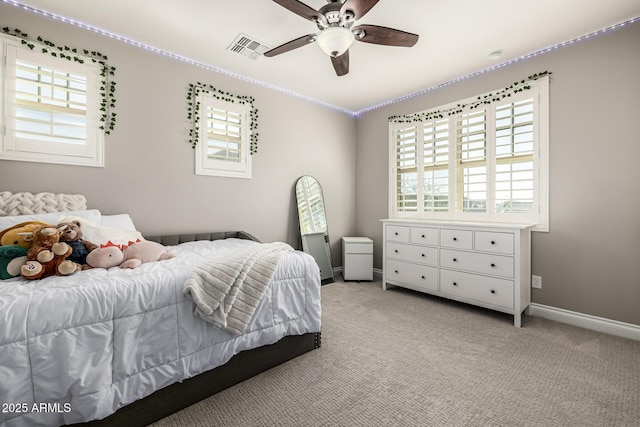 bedroom featuring visible vents, baseboards, light colored carpet, and ceiling fan