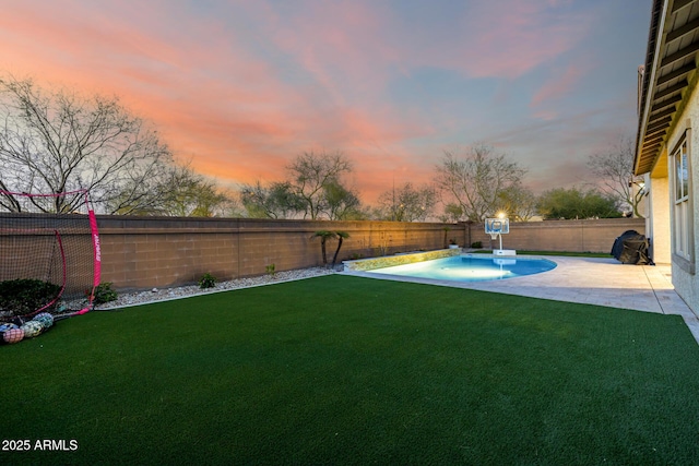 yard at dusk with a patio area, a fenced in pool, and a fenced backyard