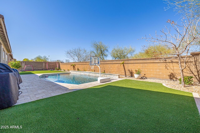 view of pool featuring a patio area, a yard, a fenced backyard, and a fenced in pool