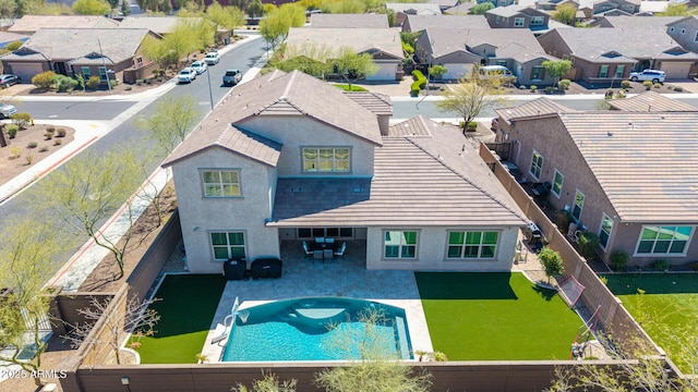 exterior space featuring a patio area, a residential view, stucco siding, and a fenced backyard