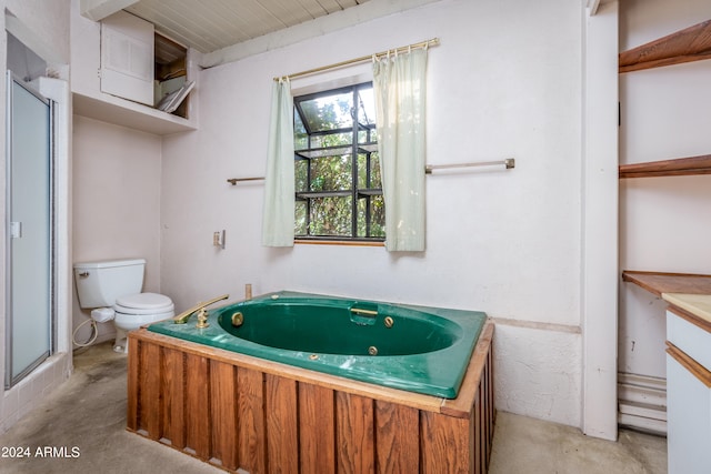 full bathroom with concrete floors, separate shower and tub, vanity, and toilet