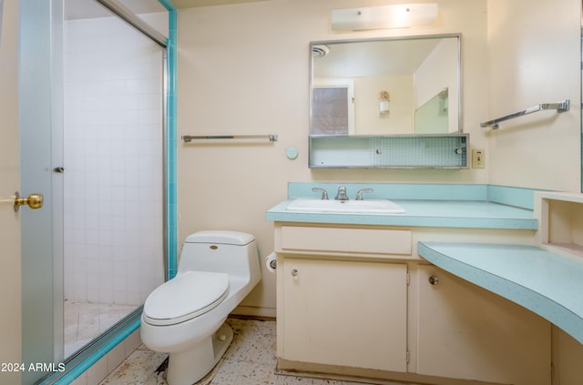 bathroom featuring vanity, toilet, and an enclosed shower