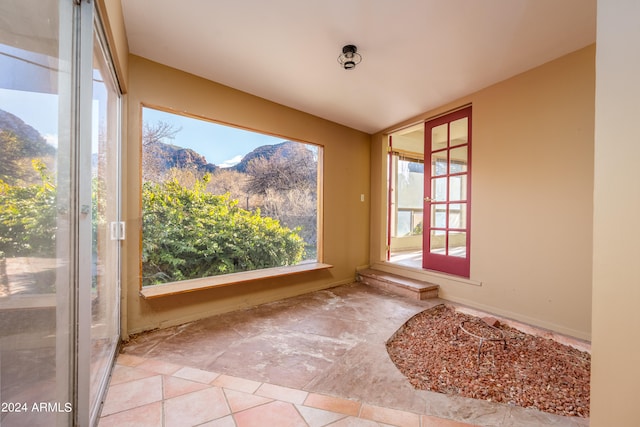 unfurnished sunroom with a mountain view