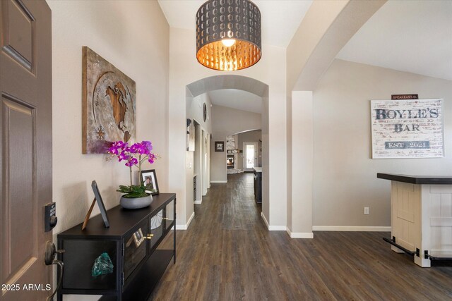 420 S Dodge Dr, Chandler, AZ 85225 - corridor with arched walkways, dark wood-type flooring, baseboards, lofted ceiling, and a chandelier