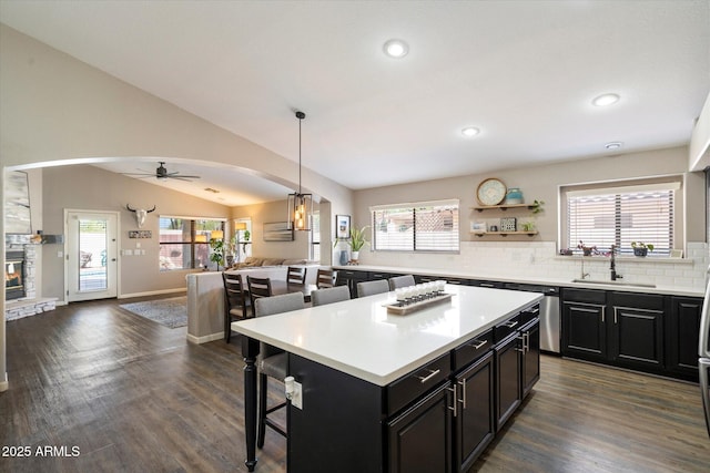 420 S Dodge Dr, Chandler, AZ 85225 - kitchen with a sink, a breakfast bar, open floor plan, arched walkways, and dark cabinets
