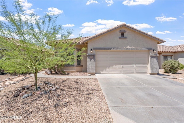 40614 N Key Ln, Anthem, AZ 85086 - mediterranean / spanish-style house featuring stucco siding, an attached garage, driveway, and a tiled roof