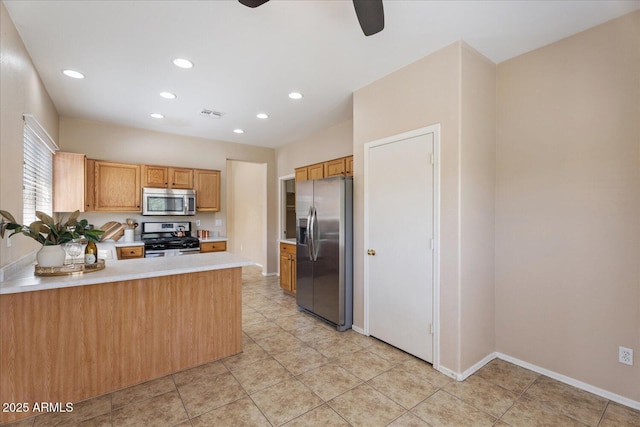 40614 N Key Ln, Anthem, AZ 85086 - kitchen with stainless steel appliances, a ceiling fan, light countertops, recessed lighting, and a peninsula
