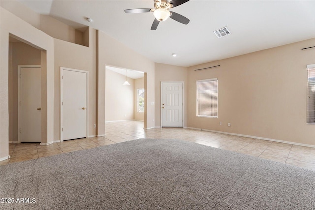 40614 N Key Ln, Anthem, AZ 85086 - carpeted empty room with tile patterned flooring, a ceiling fan, a smoke detector, and high vaulted ceiling