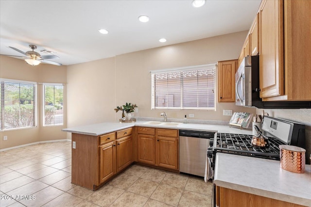 40614 N Key Ln, Anthem, AZ 85086 - kitchen with stainless steel appliances, a peninsula, light countertops, ceiling fan, and recessed lighting