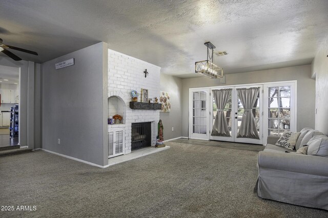 14484 W Jimmie Kerr Blvd, Casa Grande, AZ 85122 - living room with ceiling fan, baseboards, carpet, a fireplace, and a textured ceiling