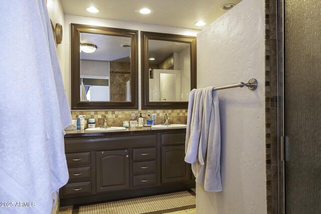 14484 W Jimmie Kerr Blvd, Casa Grande, AZ 85122 - full bathroom featuring a textured wall, double vanity, and decorative backsplash