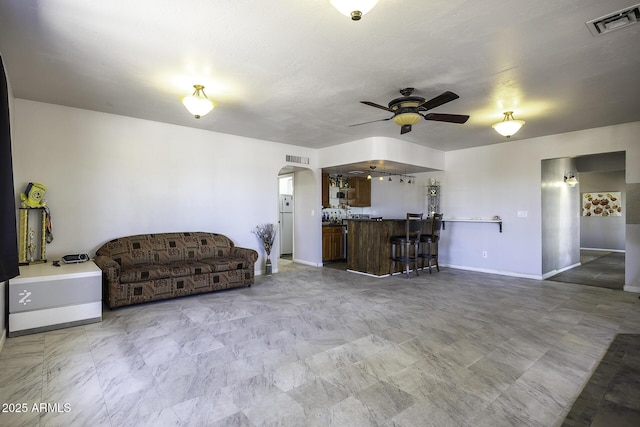 14484 W Jimmie Kerr Blvd, Casa Grande, AZ 85122 - living area with arched walkways, ceiling fan, and baseboards