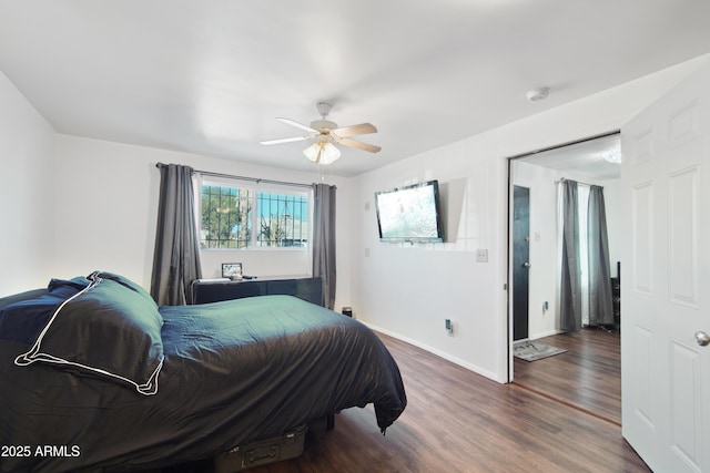 bedroom with ceiling fan and dark hardwood / wood-style floors