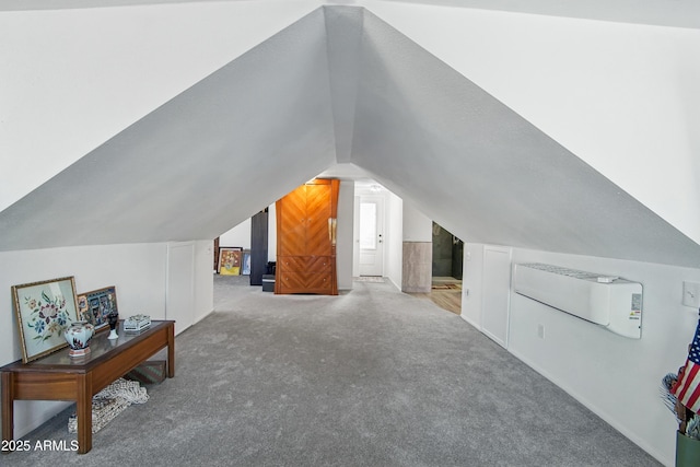 additional living space featuring lofted ceiling, carpet flooring, and an AC wall unit