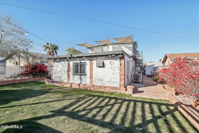 back of house featuring a patio area, a lawn, and an AC wall unit