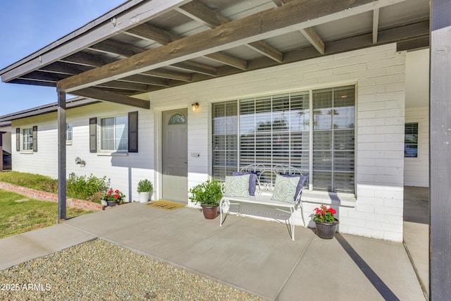 view of exterior entry with covered porch