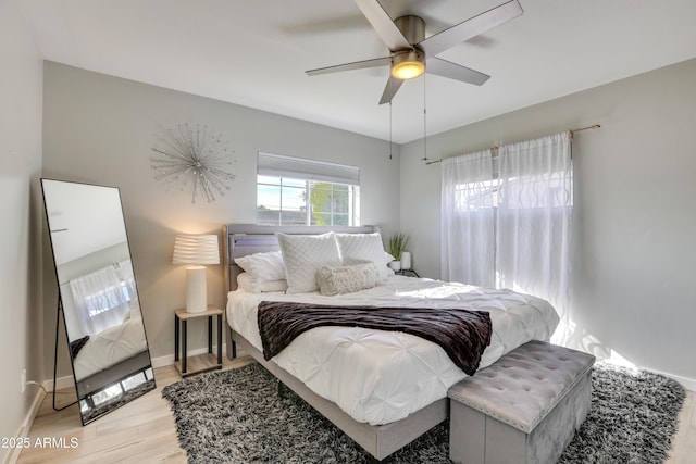 bedroom with ceiling fan and light wood-type flooring