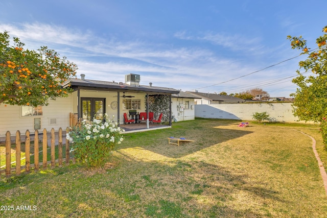 view of yard featuring central air condition unit, french doors, and a patio area