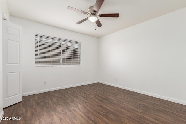 empty room with dark hardwood / wood-style floors and ceiling fan