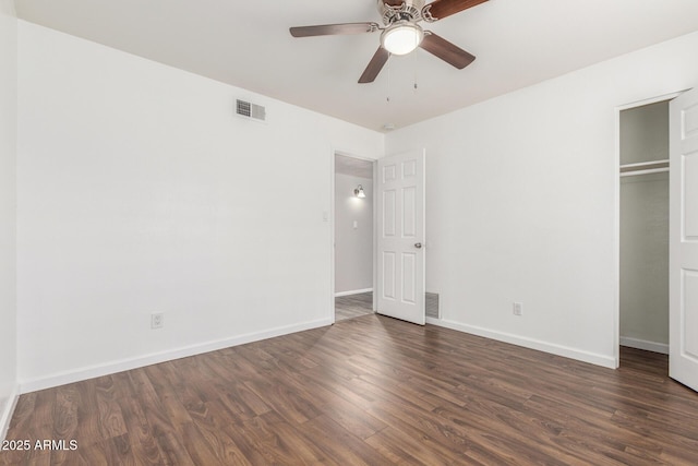 unfurnished bedroom featuring dark hardwood / wood-style flooring, a closet, and ceiling fan