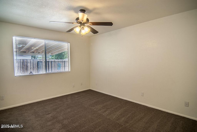 carpeted spare room with a textured ceiling and ceiling fan