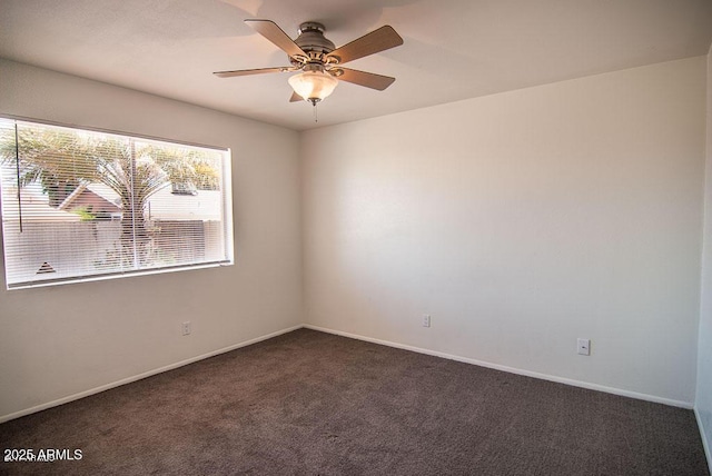 carpeted spare room with ceiling fan