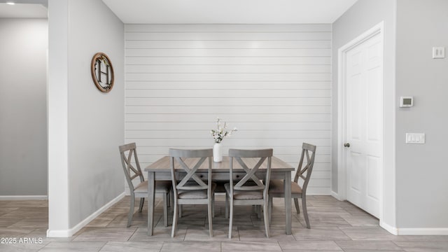 dining area with baseboards and wood finish floors