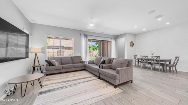 living room featuring recessed lighting, light wood-style flooring, and baseboards