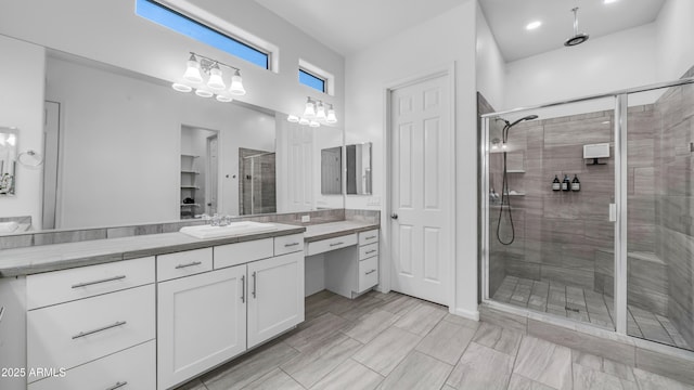full bath featuring vanity and a shower stall