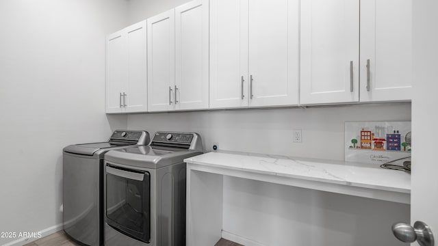washroom with independent washer and dryer and cabinet space