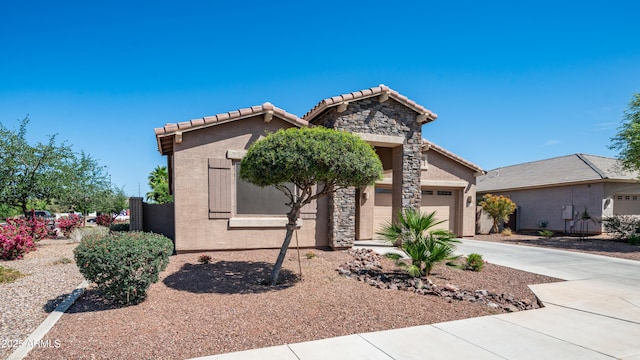 view of front of property featuring a garage, a tile roof, driveway, and stone siding