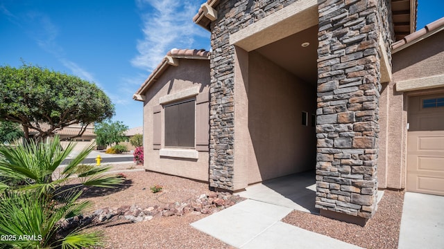 view of side of property with stone siding and stucco siding