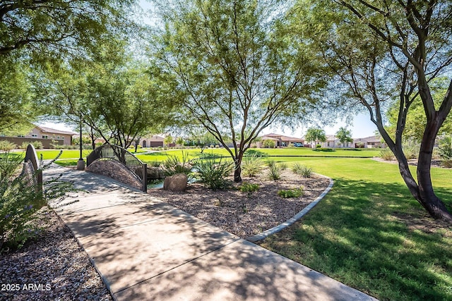 view of home's community with a residential view and a yard