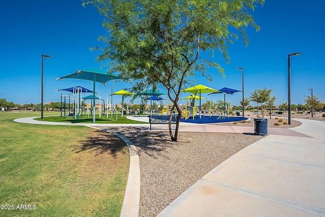 view of home's community featuring playground community and a yard
