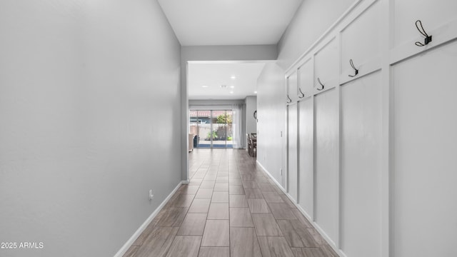 hallway featuring recessed lighting and baseboards