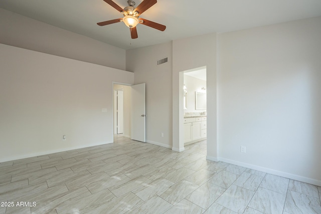 empty room with ceiling fan and lofted ceiling