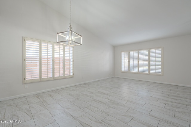 empty room with an inviting chandelier and high vaulted ceiling