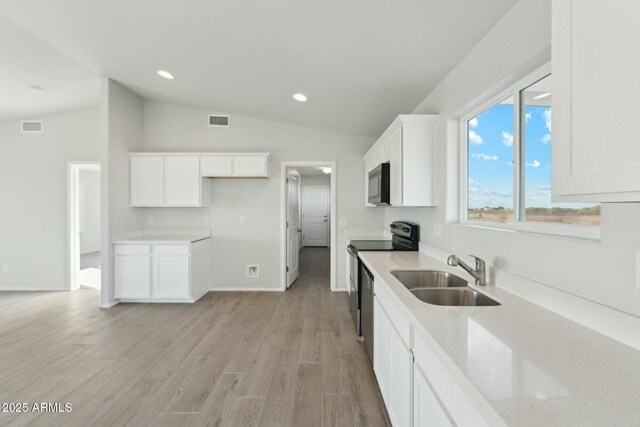 kitchen with dark hardwood / wood-style flooring, sink, decorative light fixtures, and black / electric stove