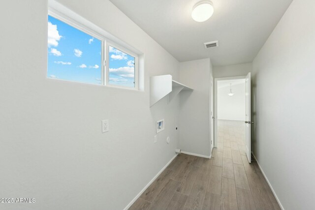 full bathroom with a healthy amount of sunlight, hardwood / wood-style floors, shower / bath combination with glass door, and toilet