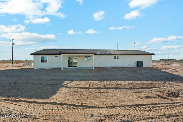 rear view of property with a patio and central air condition unit