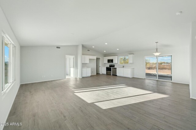 bathroom with hardwood / wood-style floors and a shower with door