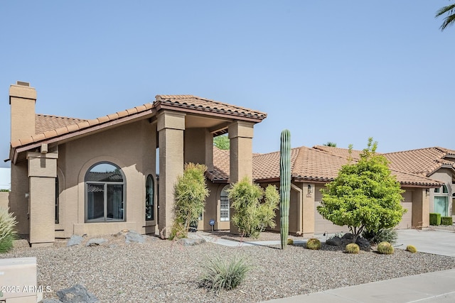 16254 N 48th Way, Scottsdale, AZ 85254 - mediterranean / spanish-style house with a tile roof, stucco siding, a chimney, and driveway