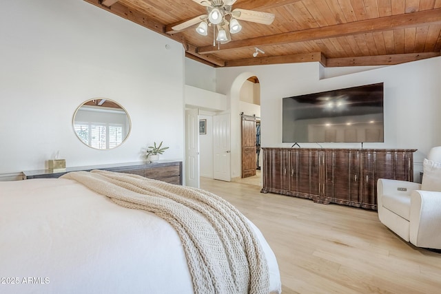 16254 N 48th Way, Scottsdale, AZ 85254 - bedroom featuring wooden ceiling, a barn door, light wood-style flooring, arched walkways, and a ceiling fan
