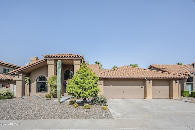 16254 N 48th Way, Scottsdale, AZ 85254 - mediterranean / spanish-style home featuring a garage, stucco siding, a tiled roof, concrete driveway, and a chimney