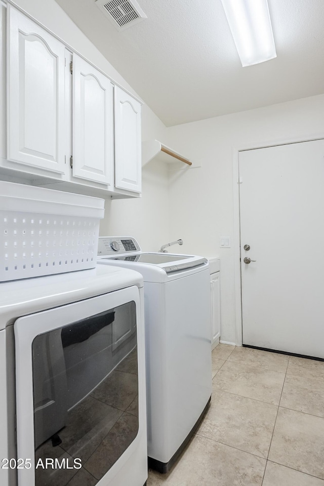 16254 N 48th Way, Scottsdale, AZ 85254 - laundry area with washing machine and clothes dryer, cabinet space, and light tile patterned floors