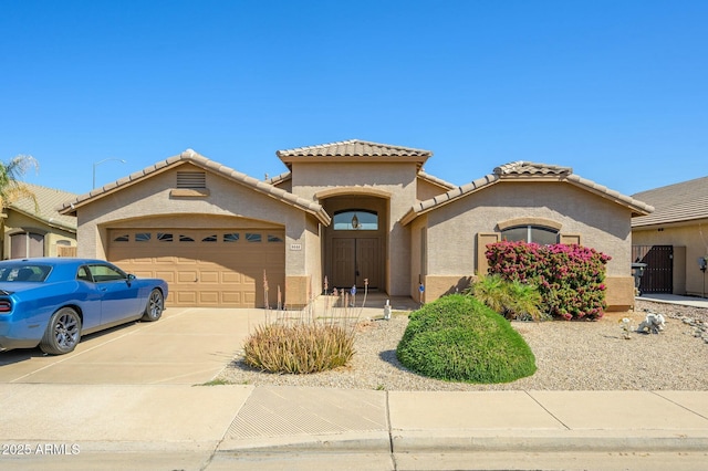 9446 E Olla Ave, Mesa, AZ 85212 - mediterranean / spanish house with a tile roof, an attached garage, driveway, and stucco siding